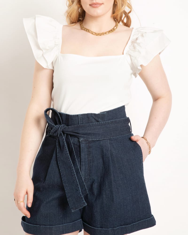 Front of a model wearing a size 14|16 Ella Flutter Sleeve Crop Top in Soft White by ELOQUII. | dia_product_style_image_id:204012